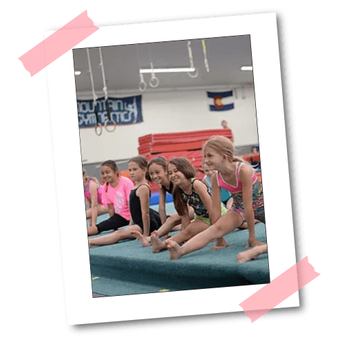 Young gymnasts stretching on the floor at Mountain Kids